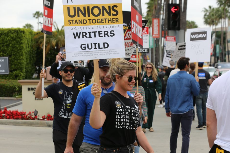 game developer office workers, union picket sign, video game controller protest