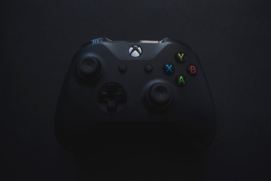 doom video game controller, empty office desks, xbox logo building