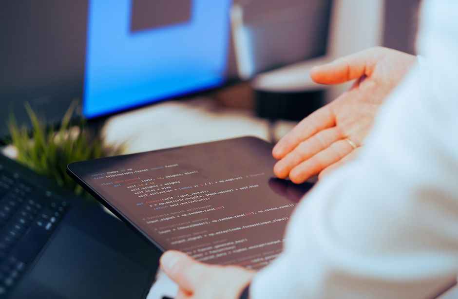 linux kernel code on screen, penguin tux logo, programmer reviewing code