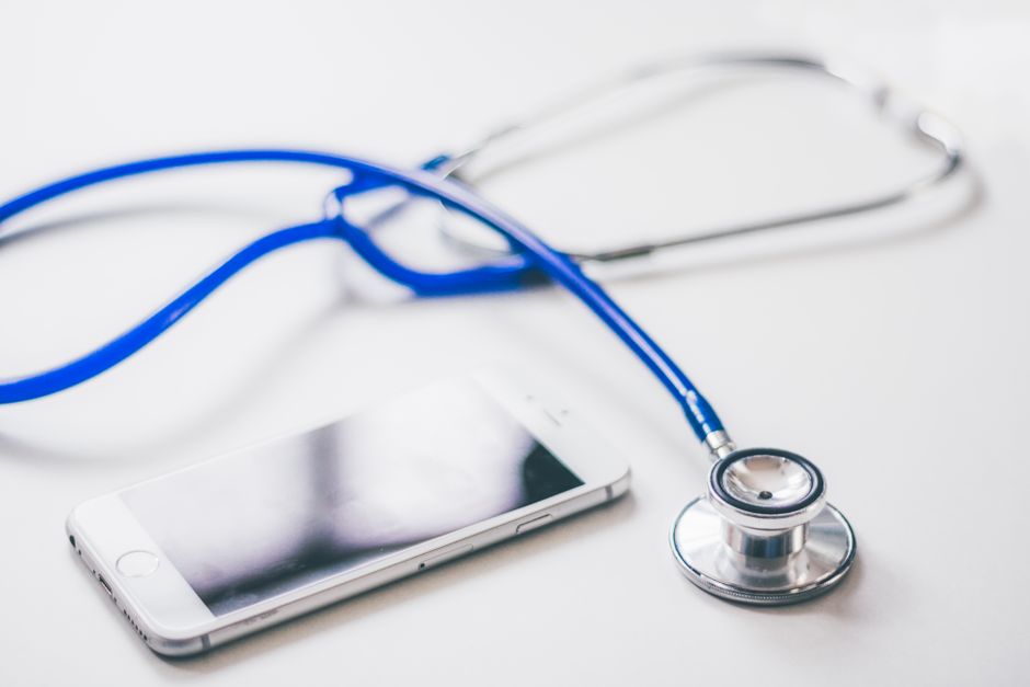 smartphone health app, doctor stethoscope laptop, medical data privacy