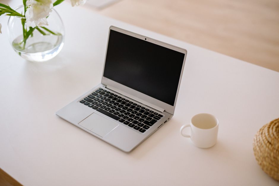 empty office desk, patreon logo screen, laptop layoff notice