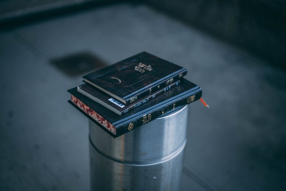stack of books, dark foggy street, horror game desk