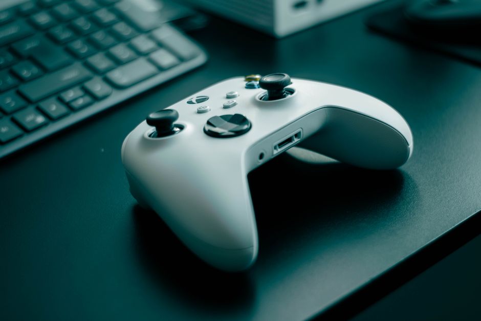 game developer workspace empty desk, video game controller on desk, office moving boxes