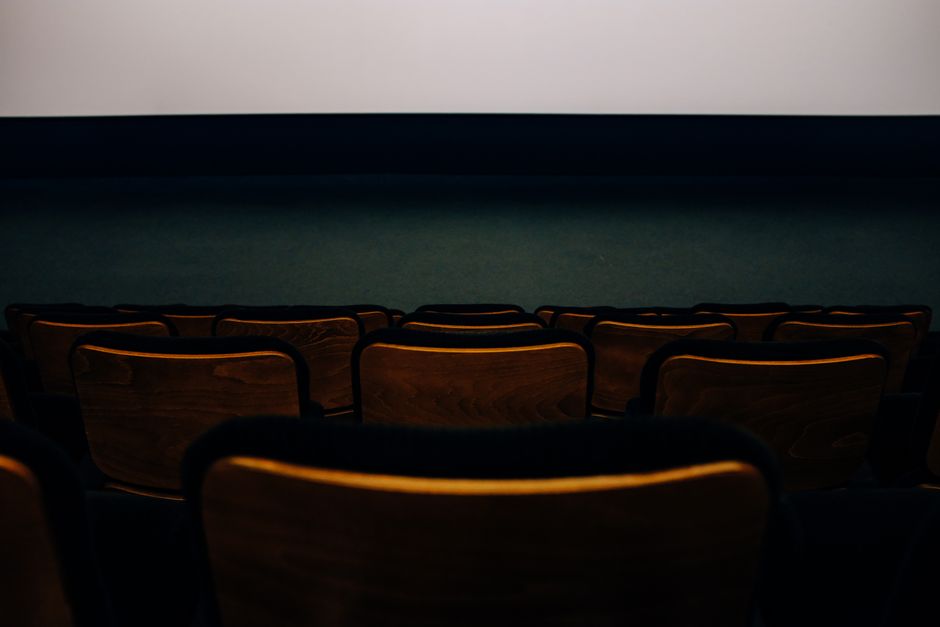 empty cinema seats, vintage film camera, forest path at dusk
