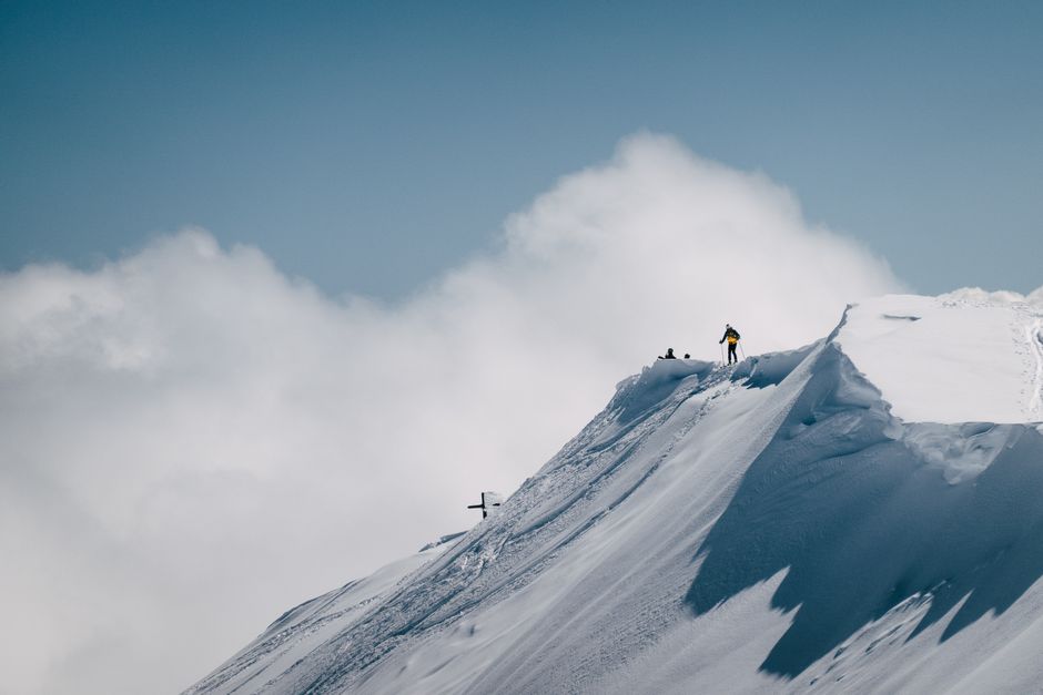 mountain climbers summit ridge, misty alpine peak, climbing rope carabiner