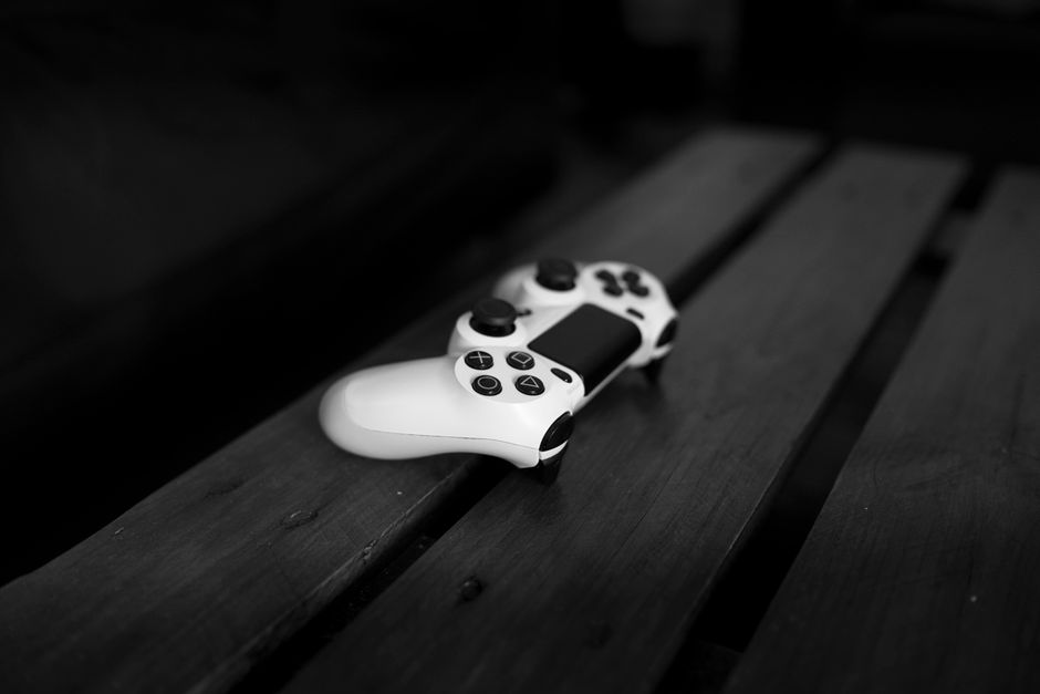 futuristic robot silhouette, abandoned industrial landscape, video game controller dark