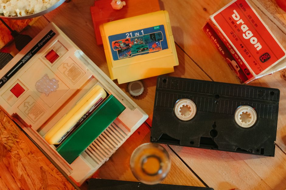 atari 2600 cartridge, vintage game cartridges stack, wood grain retro console