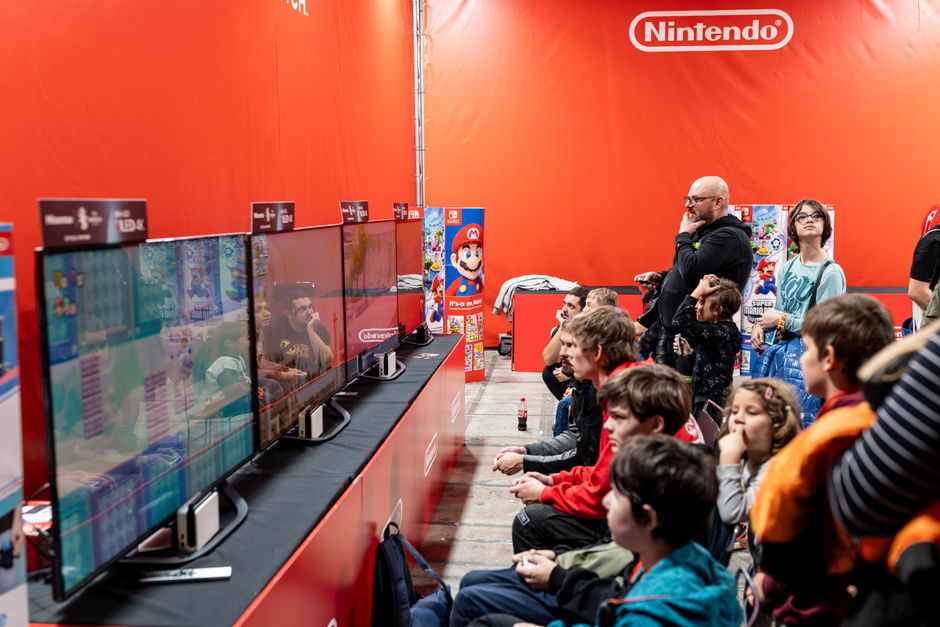 gaming convention crowd stage, esports arena big screen, video game trade show booth