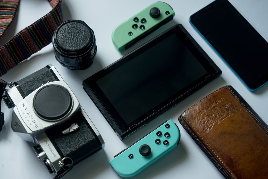 nintendo switch console, retro game controller, green forest path